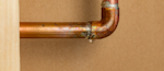 A pinhole leak on copper piping.
