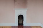 Peeling wallpaper above the damp chimney breast