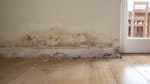 Visible salt contamination causing wallpaper to discolour and peel
