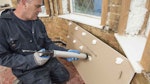 Applying Drygrip Adhesive to the back of the plasterboard