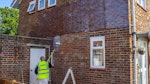 Applying Stormdry Masonry Protection Cream to the outside of the house