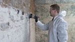 Applying Dryshield Cream to the wall