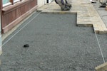 Paving being laid over aggregate and membrane