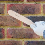 Remove surface laitance with a masonry brush