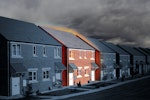 A row of houses. An orange glow emanates from the walls, ceiling and windows.