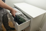 Placing clothes in a drawer