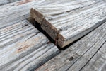 Wooden deck floor boards old, warped and weathered and coming up, need to be nailed and repaired