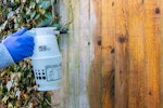 Roxil 100 Wood & Patio Cleaner being spray applied to a wooden fence panel